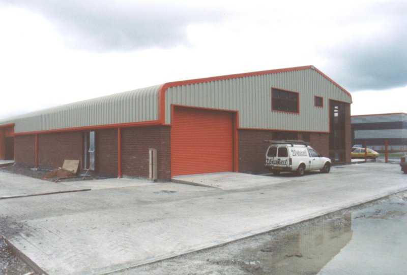Curved Eave and Red Sheeting Steel Building Industrial Factory Custom Precision UK